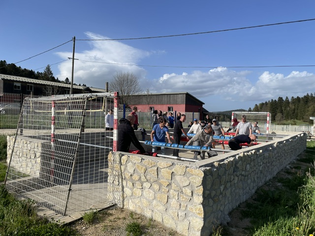 A group mid-game on the lodge's human foosball court